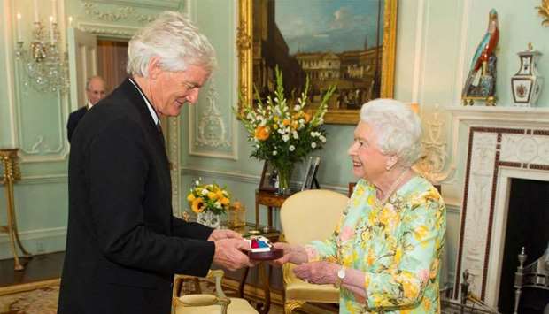 Britain's Queen Elizabeth presents James Dyson with the insignia of members of the Order of Merit, during a private audience at Buckingham Palace, London.