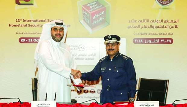 Mwani Qatar CEO Captain Abdulla al-Khanji and Milipol Qatar Committee president Brigadier Nasser bin Fahd al-Thani shake hands after signing the agreement.