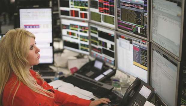 A trader monitors stock prices at the London Stock Exchange. The FTSE 100 sank 1.2% to 6,955.21 points yesterday.