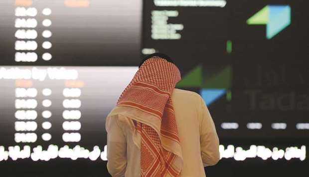 A Saudi investor monitors the stock prices at the Saudi Stock Exchange. Saudi Arabiau2019s Public Investment Fund has been indirectly supporting local stocks, using local institutions, to limit a market crash caused by the killing of Saudi journalist Jamal Khashoggi, according to sources familiar with the matter.