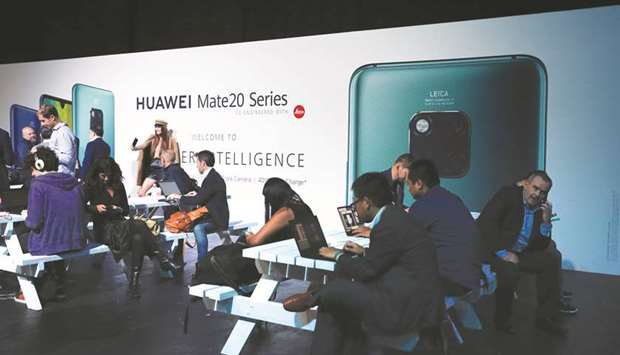 People attend a Huawei Mate 20 smartphone series launch event in London. The Chinese firm will open a new information security lab in Germany next month that will enable source code reviews, in a step aimed at winning regulatorsu2019 confidence before the countryu2019s 5G mobile spectrum auction.