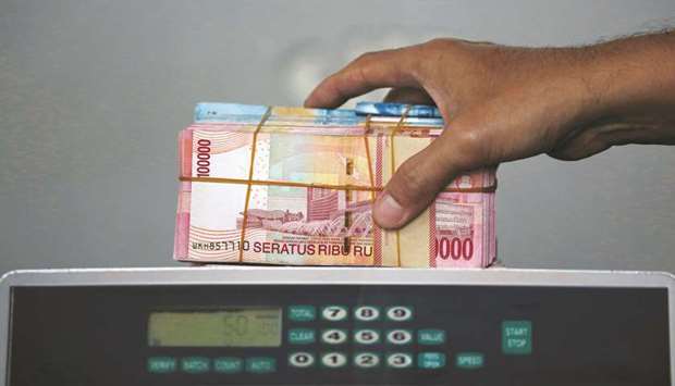 Indonesian rupiah banknotes are seen after they were counted at a money changer in Jakarta. The currency is about 11% weaker than its end-2017 level, hurt by capital outflows triggered by rising US interest rates and the US-China trade war.
