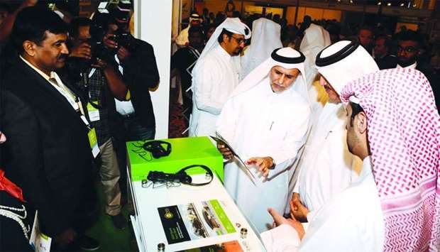 Dr Yousef Alhorr explains a green building product to the minister and guests