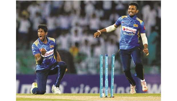 Sri Lankau2019s Kasun Rajitha (L) celebrates after taking the wicket of Englandu2019s Jason Roy (not pictured) in Colombo yesterday.
