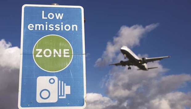 An aircraft passes a low emission zone sign as it prepares to land at Heathrow airport in London. Direct emissions from aviation account for more than 2% of global emissions. Since 1990, CO2 emissions from international aviation have increased 83%. If global aviation was a country, it would rank in the top 10 emitters.
