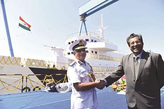 Indian Coast Guard Director General Rajendra Singh (left) and Reliance Naval and Engineering Ltd (RNEL) CEO Debashis Bir shake hands during the ceremonial ship launching of the new Indian Coast Guardu2019s Cadets Training ship named Varuna, at Pipavav, some 340kms from Ahmedabad yesterday.