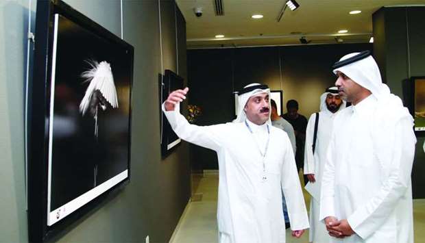 Yacoub al-Kanderi (left) shows his works to Saif Saeed al-Dosari, who opened the Kuwait exhibition 'Creative' at Katara. PICTURES: Jayaram