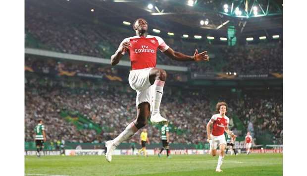 Arsenalu2019s Danny Welbeck celebrates after scoring a goal during their Europa League match against Sporting Lisbon yesterday. (Reuters)