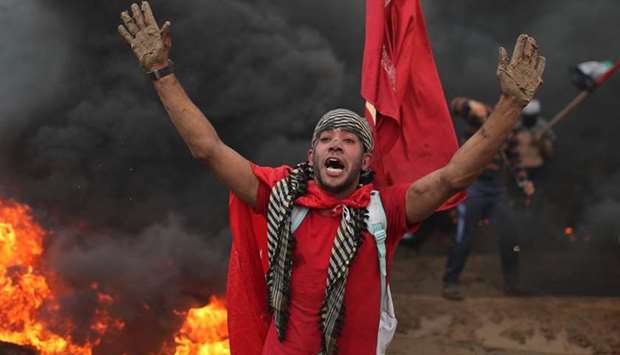 A Palestinian demonstrator reacts during a protest calling for lifting the blockade on Gaza, at the Israel-Gaza border fence in Gaza.