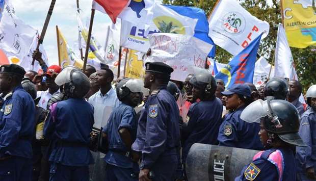 DRCongo policemen escort protesters during a march in Goma.