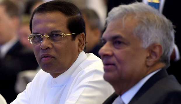 In this file photo taken on October 11, 2018, Sri Lankan President Maithripala Sirisena (L) and Sri Lankan Prime Minister Ranil Wickremasinghe sit together during the opening of the seminar ,The Indian Ocean: Defining our Future, in Colombo. AFP