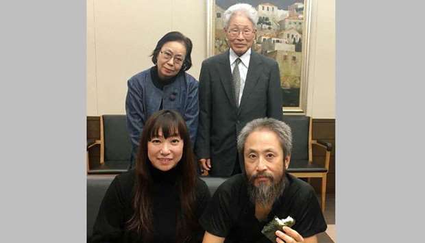 Japanese freelance journalist Jumpei Yasuda (front right), who was kidnapped in Syria three years ago, poses with his wife Myu and his parents, Sachiko (back left) and Hideaki (back right) upon his arrival at Narita Airport, in Chiba Prefecture.