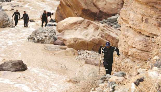 Civil defence members look for survivors after rain storms  unleashed flash floods, near the Dead Sea, Jordan, yesterday.
