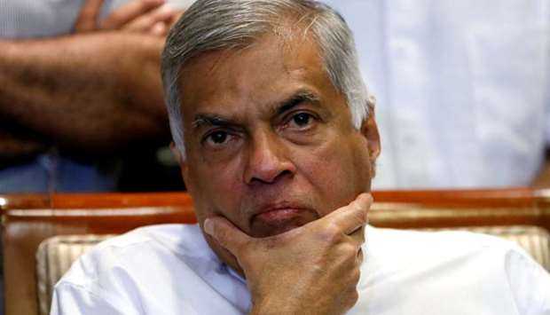 Sri Lanka's ousted Prime Minister Ranil Wickremesinghe reacts during a news conference in Colombo