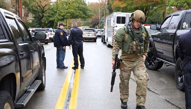 A SWAT police officer and other first responders respond after a gunman opened fire at the Tree of Life synagogue in Pittsburgh