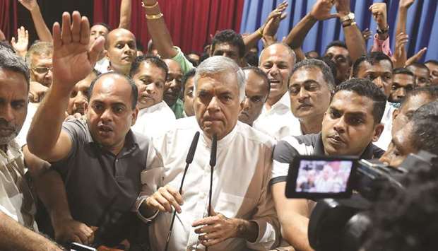 Sri Lankau2019s ousted prime minister Ranil Wickremesinghe, centre, speaks to his supporters at the prime ministeru2019s official residence in Colombo yesterday.
