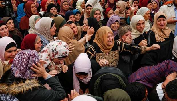 Palestinian mourners react during the funeral