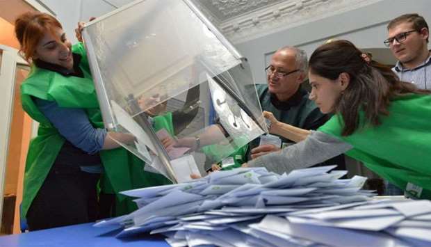 Election Commission officials count votes after presidential election at a polling station in Kutaisi