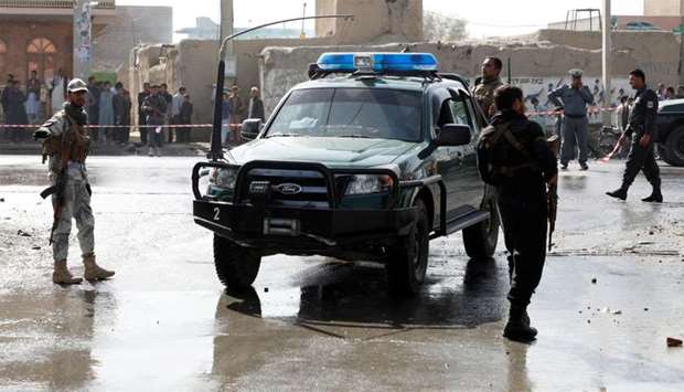Afghan policemen keep watch at the site of a suicide attack in Kabul