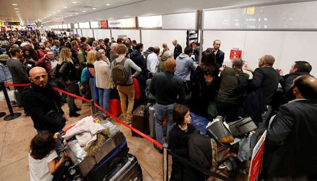 Passengers wait during a strike by Aviapartner baggage handlers at Zaventem international airport near Brussels
