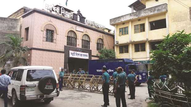 Police stand guard in front of a jail-turned-court where a verdict was being delivered on a graft case against BNP leader Khaleda Zia in Dhaka yesterday.