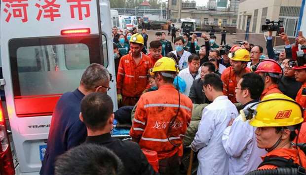 Rescuers and medical staffs transferring an injured miner after a mining accident in Yuncheng County in China's eastern Shandong province