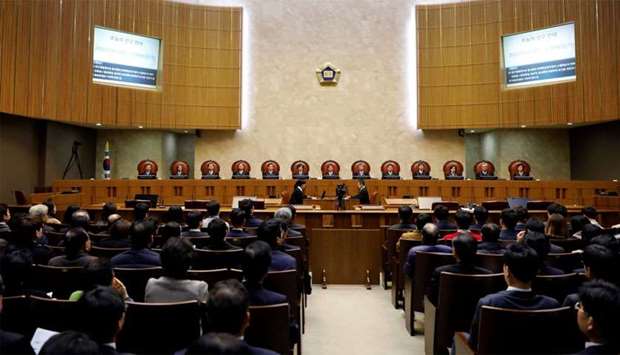 Judges of South Korea's Supreme Court sit as Lee Choon-shik (obscured), victim of wartime forced labor during the Japanese colonial period, attends to hear the court ruling in Seoul