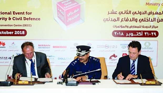 Major General Nasser bin Fahad al-Thani flanked by GIE Milipol chairman Yann Jounot and ComexposiumCenter president Renaud Hamaide at a signing ceremony.