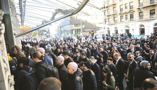 Attendees arrive at the Brooklyn Academy of Music in New York ahead of an Apple event yesterday. Apple yesterday introduced new versions of the iPad Pro with thinner bezels and more screen space, along with the face unlock system found on Appleu2019s newer iPhones.