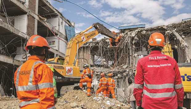 Search and rescue team members use an excavator to search for victims of the earthquake in the rubble of Anutapura hospital in Palu, Central Sulawesi, Indonesia, on October 9. The UNDP is co-operating with the national zakat collection agency to set up funds for renewable energy projects in underserved communities and provide emergency relief to people affected by the latest earthquakes and the tsunami in Central Sulawesi and Lombok.