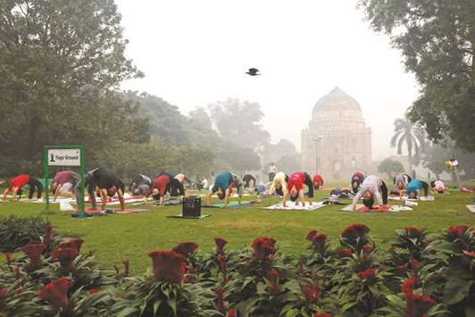 People exercise at a park on a smoggy morning in New Delhi yesterday.