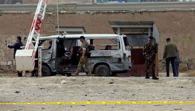 Afghan security forces inspect the site of a suicide attack in Kabul