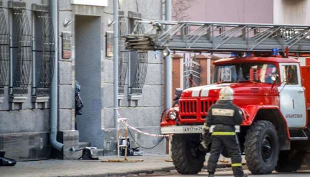 A Russian firefighter walks near a fire-engine at building housing the FSB security service in Arkhangelsk