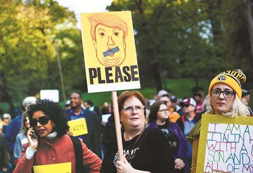 People protesting against President Donald Trump wait near the Tree of Life Congregation on Tuesday in Pittsburgh.