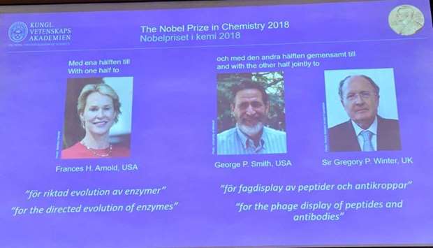 Pictures of the 2018 Nobel Prize laureates for chemistry: Frances H. Arnold of the United States, George P. Smith of the United States and Gregory P. Winter of Britain are displayed on a screen during the announcement at the Royal Swedish Academy of Sciences, in Stockholm,