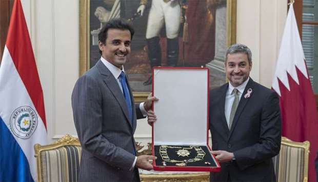 His Highness the Amir Sheikh Tamim bin Hamad al-Thani being honoured with Mariscal Lopez necklace by President of Paraguay Mario Abdo Benitez at the Presidential Palace in recognition of the close relations between Qatar and the government and people of Paraguay.