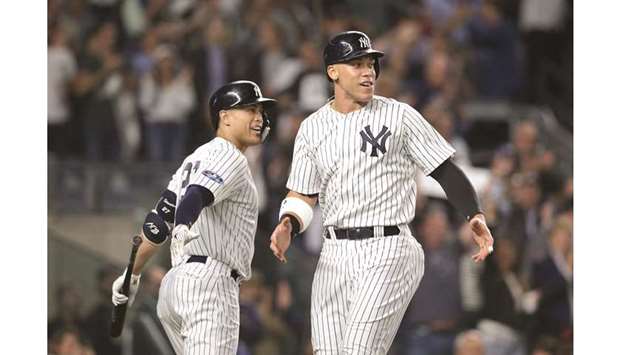 New York Yankees right fielder Aaron Judge (right) and left fielder Giancarlo Stanton celebrate during the sixth inning against the Oakland Athletics in the 2018 American League wild card playoff game at Yankee Stadium. PICTURE: USA TODAY Sports
