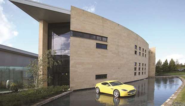An Aston Martin V8 Vantage sits outside the Aston Martin headquarters in Gaydon, UK (file). Aston Martin was priced at u00a319 a share in an initial public offering on Wednesday, on par with Ferrariu2019s lofty profit multiples. But by dayu2019s end, the stock had slipped 4.7%, and continued its downward slide on Thursday, losing 0.6% in London.