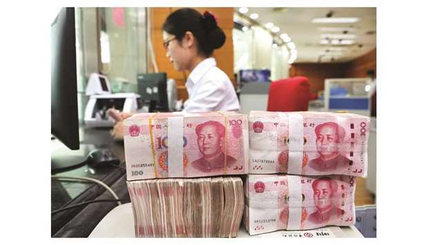 An employee counts 100-yuan notes at a bank in Nantong, Jiangsu province. Chinese banks are estimated to have issued 1.35tn yuan ($196.56bn) in net new yuan loans in September, compared to 1.28tn yuan in August, according to the poll that surveyed 26 analysts.