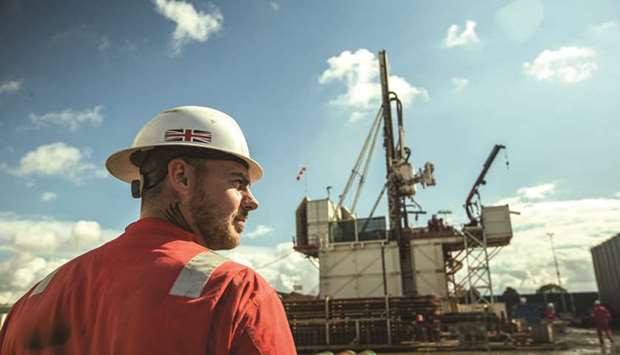 A worker stands near the drill rig at the Preston New Road pilot gas well site, operated by Cuadrilla Resources, near Blackpool, the UK. The government, keen to cut Britainu2019s reliance on gas imports which soared to more than 50% of supplies earlier this year, gave consent for Cuadrilla to go ahead with fracking again in northwest England.