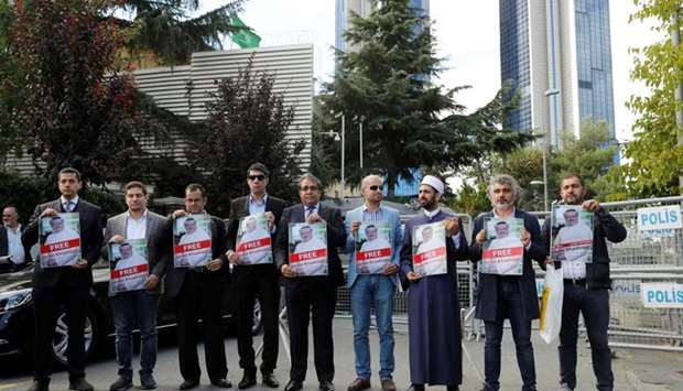 Demonstrators hold pictures of Saudi journalist Jamal Khashoggi during a protest in front of Saudi Arabia's consulate in Istanbul, Turkey