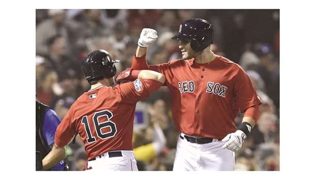Boston Red Sox designated hitter JD Martinez (right) celebrates with Red Sox left fielder Andrew Benintendi after hitting a three run home run during the first inning against the New York Yankees in game one of the ALDS at Fenway Park. PICTURE: USA TODAY Sports