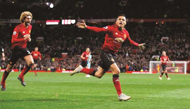 Manchester Unitedu2019s Alexis Sanchez (right) celebrates after scoring the winner with teammate Marouane Fellaini during the English Premier League match against Newcastle at Old Trafford in Manchester, England, yesterday. (Reuters)