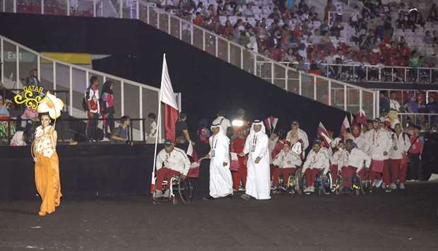 Qatari athlete Nasser al-Sahoti carries the national flag during the Asia Para Games opening ceremony in Jakarta yesterday.