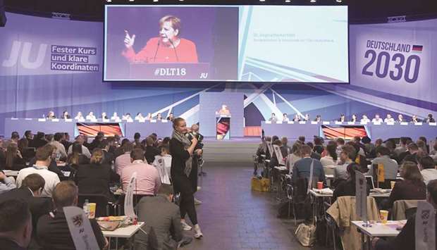 Merkel is displayed on a giant screen as she gives a speech during a congress with her conservative CDU/CSU unionu2019s youth organisation Junge Union (JU) in Kiel, northern Germany.