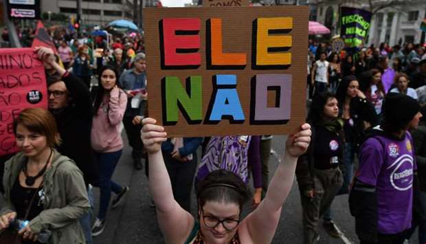 Demonstrators take part in a women protest against Brazilian right-wing presidential candidate Jair Bolsonaro called by a social media campaign under the hashtag #EleNao (Not Him) in Sao Paulo, Brazil, yesterday.
