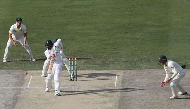 Pakistan cricketer Mohammad Hafeez (R) bats on day one of the 1st Test cricket match between Australia and Pakistan at the Dubai International Cricket Stadium