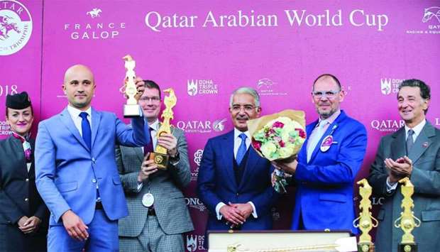 His Highness Sheikh Abdullah bin Khalifa al-Thani (third from right) with the winners of the Qatar Arabian World Cup (Group 1 PA) after Fazza Al Khalediah won the Arabian feature on Day Two of the Qatar Prix de lu2019Arc de Triomphe at Longchamp racecourse in Paris on Sunday