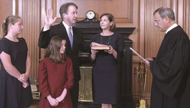 Kavanaugh is sworn in as an Associate Justice of the US Supreme Court by Chief Justice John G Roberts, Jr, with Kavanaughu2019s wife Ashley holding the bible, and his daughters Liza and Margaret in attendance.