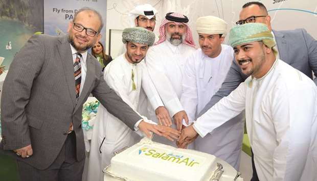 Omani ambassador Najib bin Yahya al-Balushi joins other dignitaries at the cake-cutting ceremony during the opening of SalamAiru2019s new Doha office yesterday. PICTURE: Thajudheen